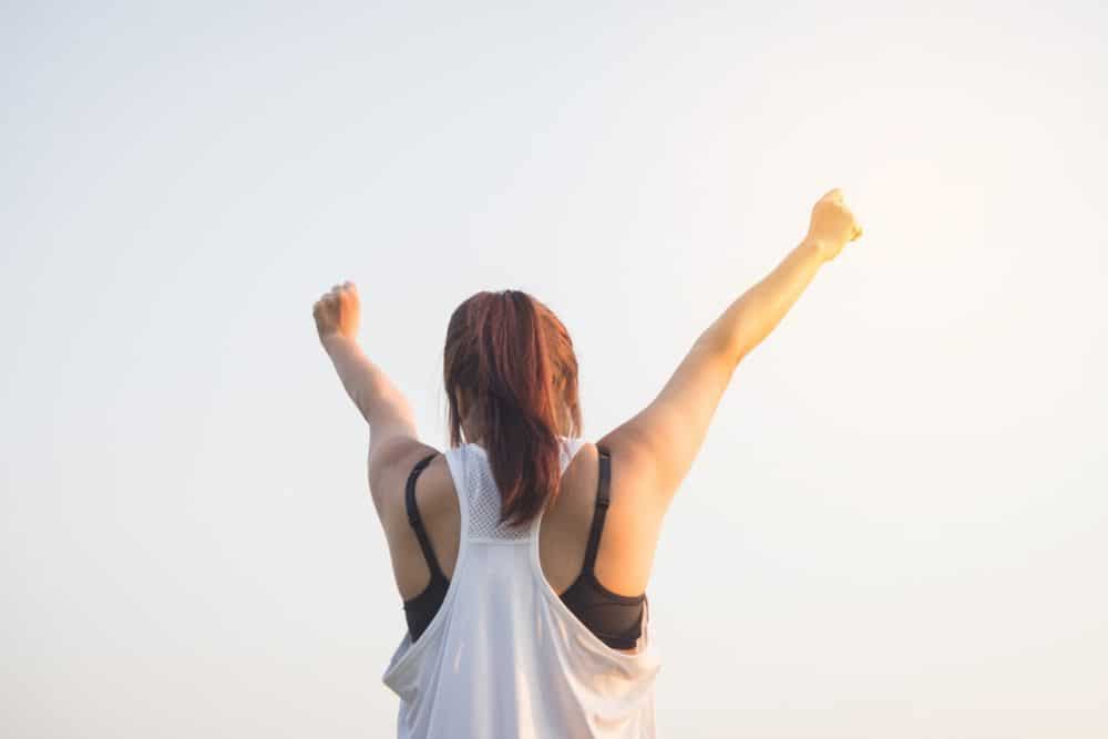 Woman raising arms in victory